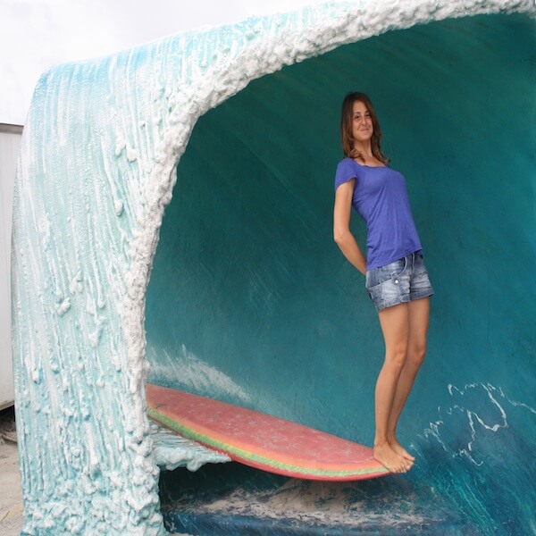 Surf Lisbon Team Susana Coelho is on a board posing for the photograph
